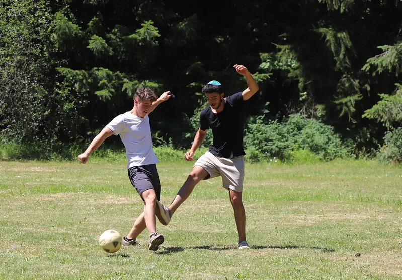 Campers playing soccer on a field